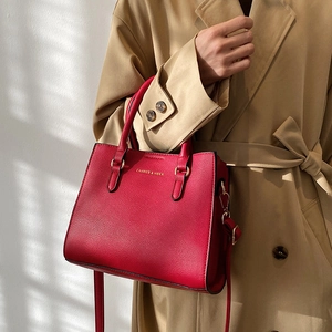 Elegant red leather wedding handbag with gold lettering and adjustable shoulder strap