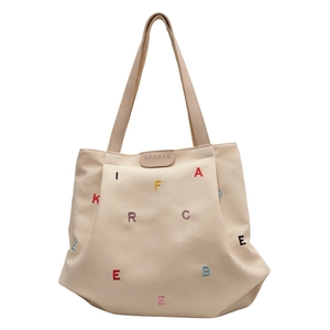 Beige canvas tote bag with colorful embroidered letters and leather brand label