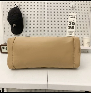 Detailed side view of khaki nylon travel bag with smooth zipper closure for travel