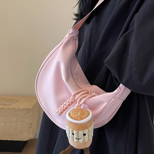 Pink nylon half-moon crossbody bag with cute plush coffee cup charm and wide strap