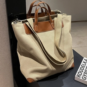 Bolso tote minimalista de lona con asas de cuero marrón y correa de hombro ajustable para mujer