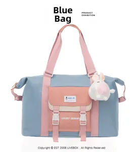 Detail der blau-rosa Reisetasche mit Tragegriff und Plüsch-Hasen-Anhänger