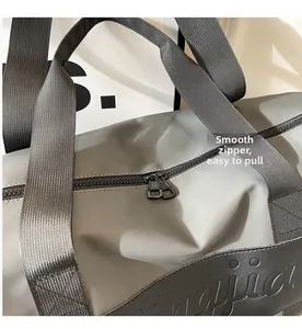 Macro shot of smooth dual metal zippers and durable nylon fabric on grey gym bag