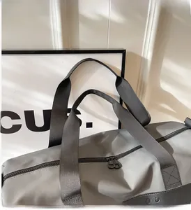 Detail of durable nylon carry handles and zipper on a black large fitness bag