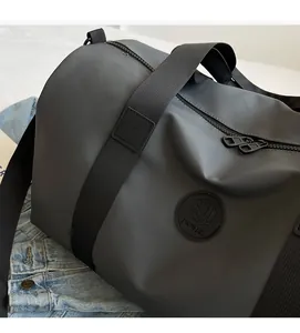 Close-up of grey travel bag featuring durable textured fabric and dual metal zippers