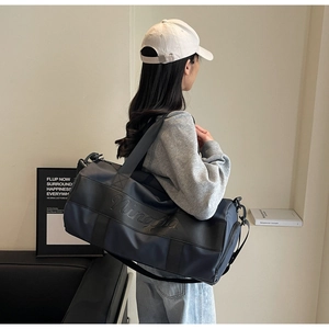 Close-up of waterproof nylon duffle bag with Ningjia embossed logo and shoulder strap