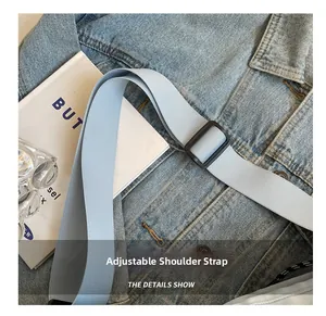 Detail of light blue nylon adjustable shoulder strap with black buckle on travel bag