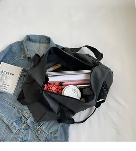 Spacious interior of black nylon travel bag showing high-capacity storage for daily essentials