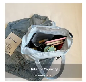 Internal capacity detail showing tablet and essentials inside large blue travel tote bag