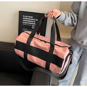 Detail of pink and black nylon travel bag with Ningjia logo and adjustable strap