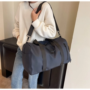 Detail of navy nylon travel bag showing durable water-resistant fabric and adjustable strap