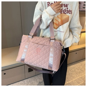 Pink quilted nylon tote bag with NINOJIA logo detail shown from a 45-degree angle