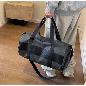 Detail of dark grey nylon travel bag with black ribbed straps and Ningjia logo