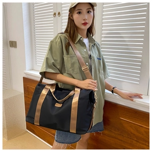 Détail du grand sac de voyage noir en tissu oxford avec bandoulière réglable or cuivré
