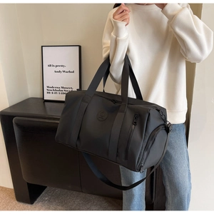 Detailed view of the black large capacity nylon travel bag with shoulder strap