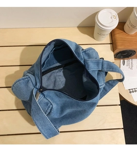 Top view of large capacity blue denim hobo bag showing spacious interior and dark lining