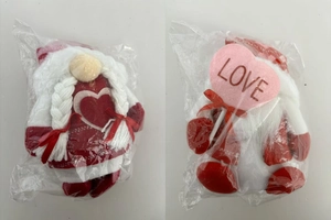 Detail of Valentine's Gnomes plush ornaments with heart decor and LOVE sign in packaging
