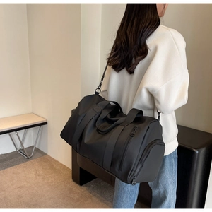 Detail of waterproof nylon travel bag with adjustable strap and sturdy double handles