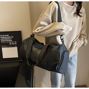 Detailed shot of large black nylon travel bag with King embossed logo and shoulder strap