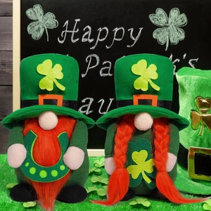 Macro shot of St. Patrick's Day gnome dolls with green clover hats and braided orange hair