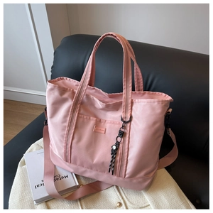 Pink large nylon tote bag featuring durable handles and functional front pocket