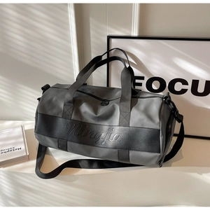 Detail view of large nylon travel bag with branded straps and textured finish
