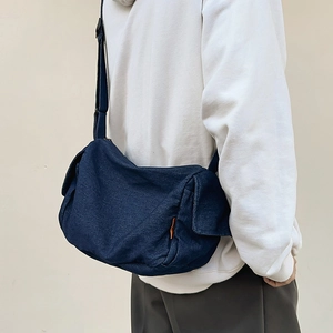 Large dark blue denim crossbody bag for women with adjustable strap and side pockets