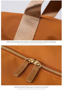 Détails des poignées renforcées et des fermetures éclair en métal de ce sac de voyage