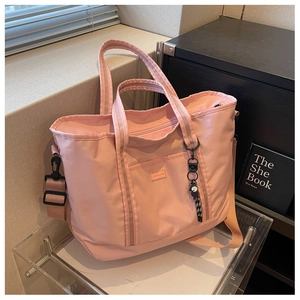 Close-up of pink large capacity travel tote bag with KINGJIA logo and adjustable strap