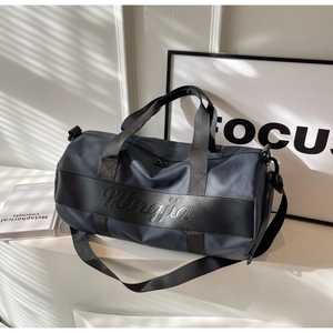 Detail of the high-quality nylon travel bag featuring the embossed brand logo and dual zipper