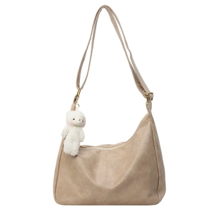 Large beige PU leather tote bag with a plush bear charm and adjustable shoulder strap