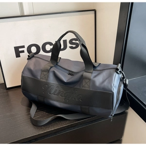 Detailed view of the Ningjia travel bag featuring a wide leather band and metal hooks