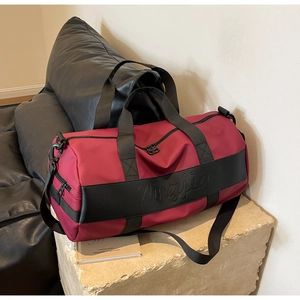 Close-up of waterproof nylon travel bag featuring Ningjia logo and red texture