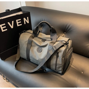 Detail view of large nylon travel bag with shoe compartment and adjustable shoulder strap