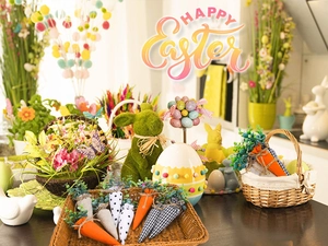 Close-up of Easter carrot decorations and flocked bunny in a festive table setting
