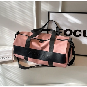 Pink and black nylon duffel bag with durable shoulder straps and zipper details