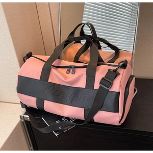 Detail view of pink travel bag showing Ningjia embossed logo and durable nylon texture