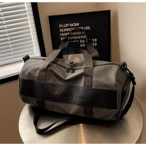 Detail of grey nylon travel bag with Ningjia brand logo and sturdy handles