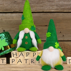 Detailed plush texture of St. Patrick's Day gnomes with shamrocks on wooden background