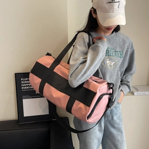 Pink nylon duffle bag with black straps and adjustable shoulder strap for travel and gym