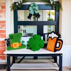 Detailed plush Saint Patrick's Day shamrock, beer mug, and hat festive pillows on a bench