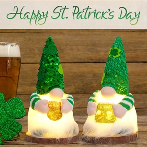Close-up of glowing St. Patrick's Day gnomes with green sequins and shamrock on wood