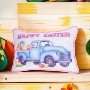 Easter throw pillow featuring a vintage blue truck with colorful eggs on a wooden shelf