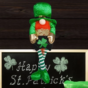 Detail of a St. Patrick's Day gnome with green hat and orange beard on a wooden background