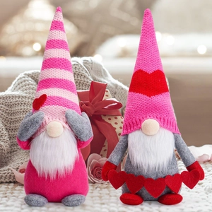 Pink Valentine's Day plush gnomes with knitted hats and red hearts holiday decor