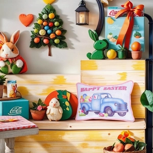 Detail view of Easter pillow with retro blue truck and colorful eggs on wooden bench