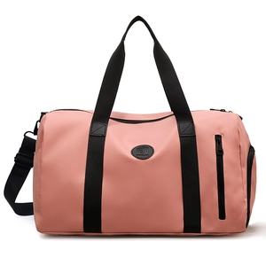 Pink large nylon travel duffel bag with black handles and detachable shoulder strap