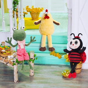 Detailed view of plush frog, yellow chicken and ladybug dolls with long legs for decoration