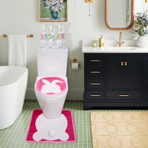 Close-up of Easter bathroom set with pink bunny silhouette bath mat and toilet cover