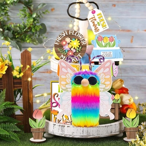Rainbow gnome with butterfly wings and sunglasses on a tiered spring flower display